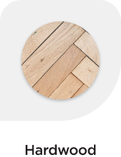 A circular image showcasing a light coloured hardwood flooring
