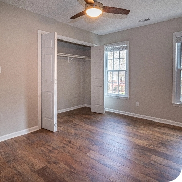 Empty room with light brown walls and darj hardwood flooring